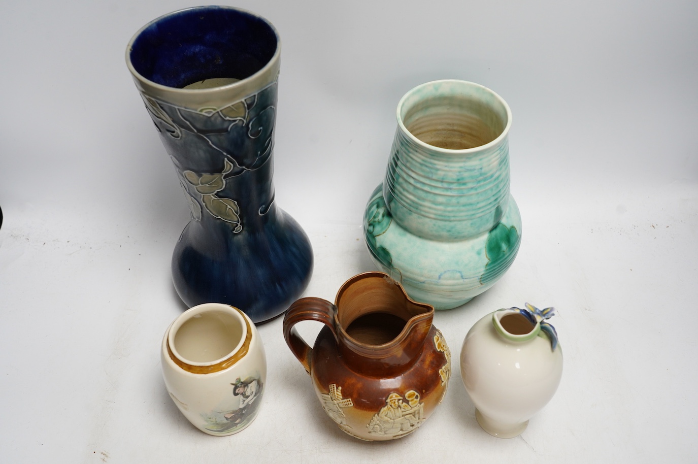 A Doulton Lambeth stoneware vase, a G.M. For Beswick vase, a Franz vase, a James Nicoll & Son and a Doulton stoneware jug, tallest 27cm. Condition - chips to Doulton